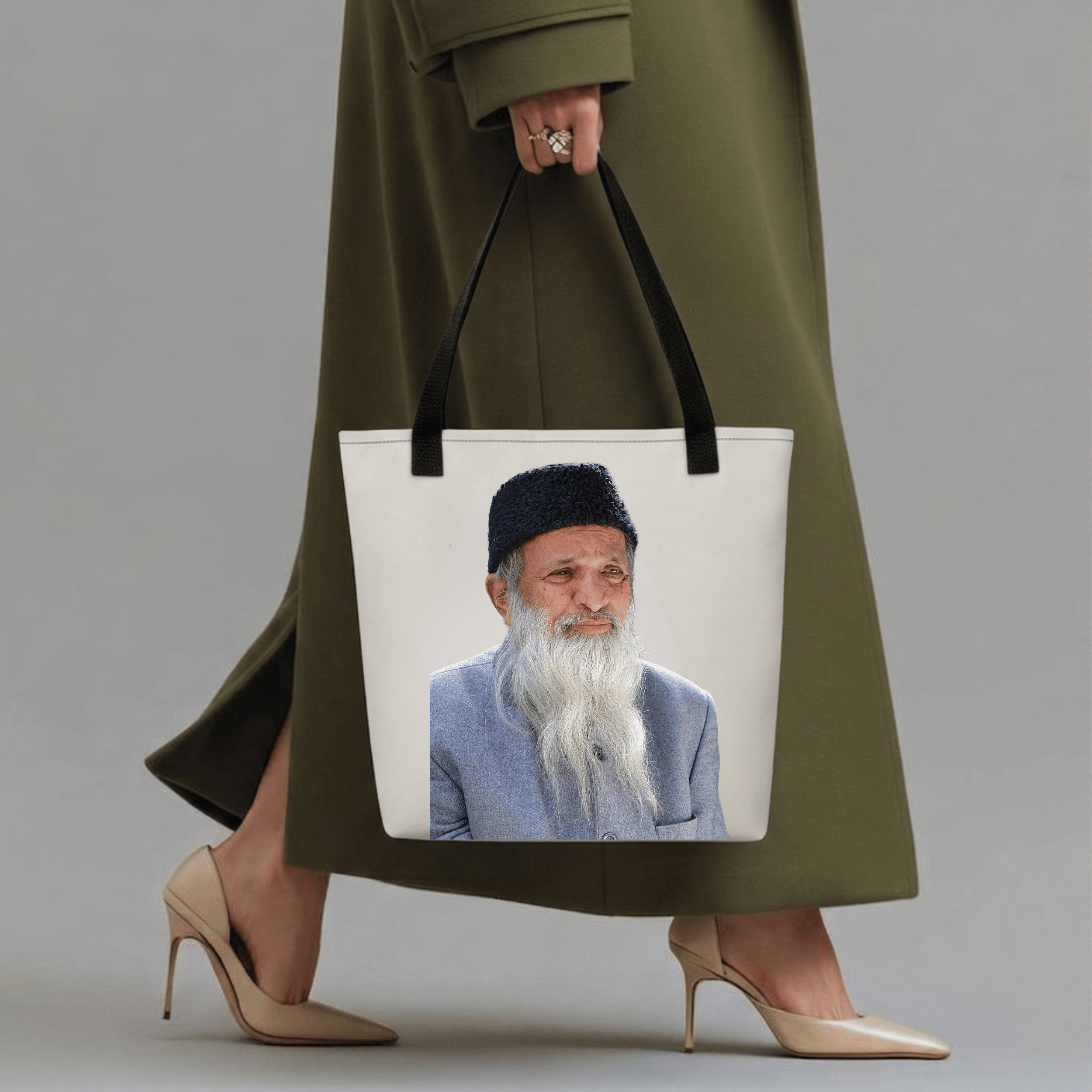 Abdul Sattar Edhi Heritage Tote Bag with full-color portrait print, held by a woman in an olive coat